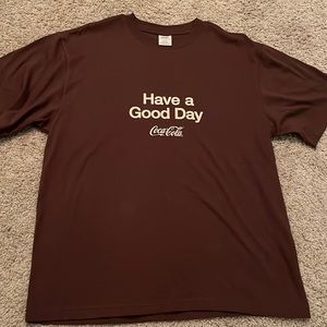 brown coca cola shirt